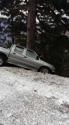 Buz tutan yolda önlemini almayan bir sürücü lastiklerinin kaymasıyla önünde bulunan ağaç sayesinde uçuruma yuvarlanmaktan kurtuluyor.