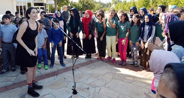 Ezo Sunal, gitar çaldı; çocuklarla şarkılar söyledi