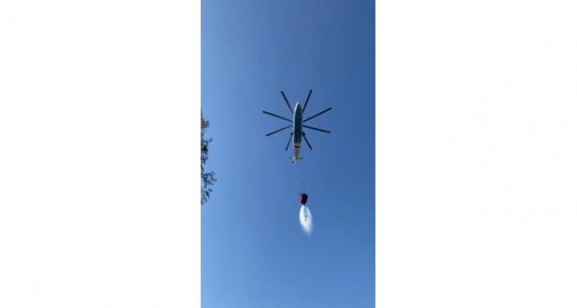 Helikopterin soğutma çalışmasını çeken muhabirler tonlarca suyun altında kalıyordu